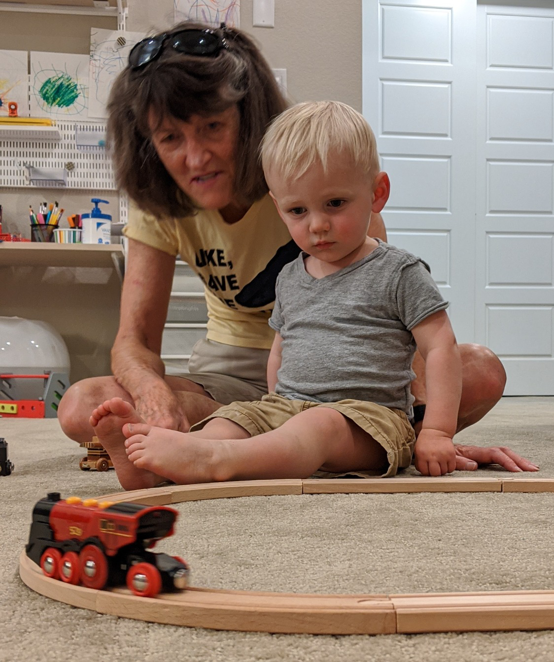 Grandma Ellen and Owen playing with trains.