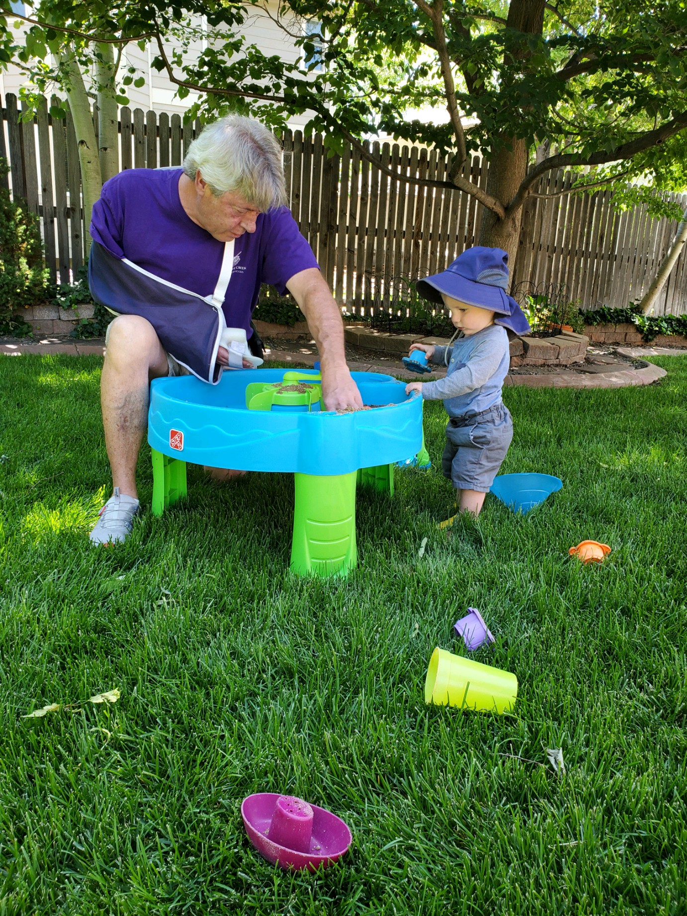 Grandpa Kim and Owen playing in the backyard with water.