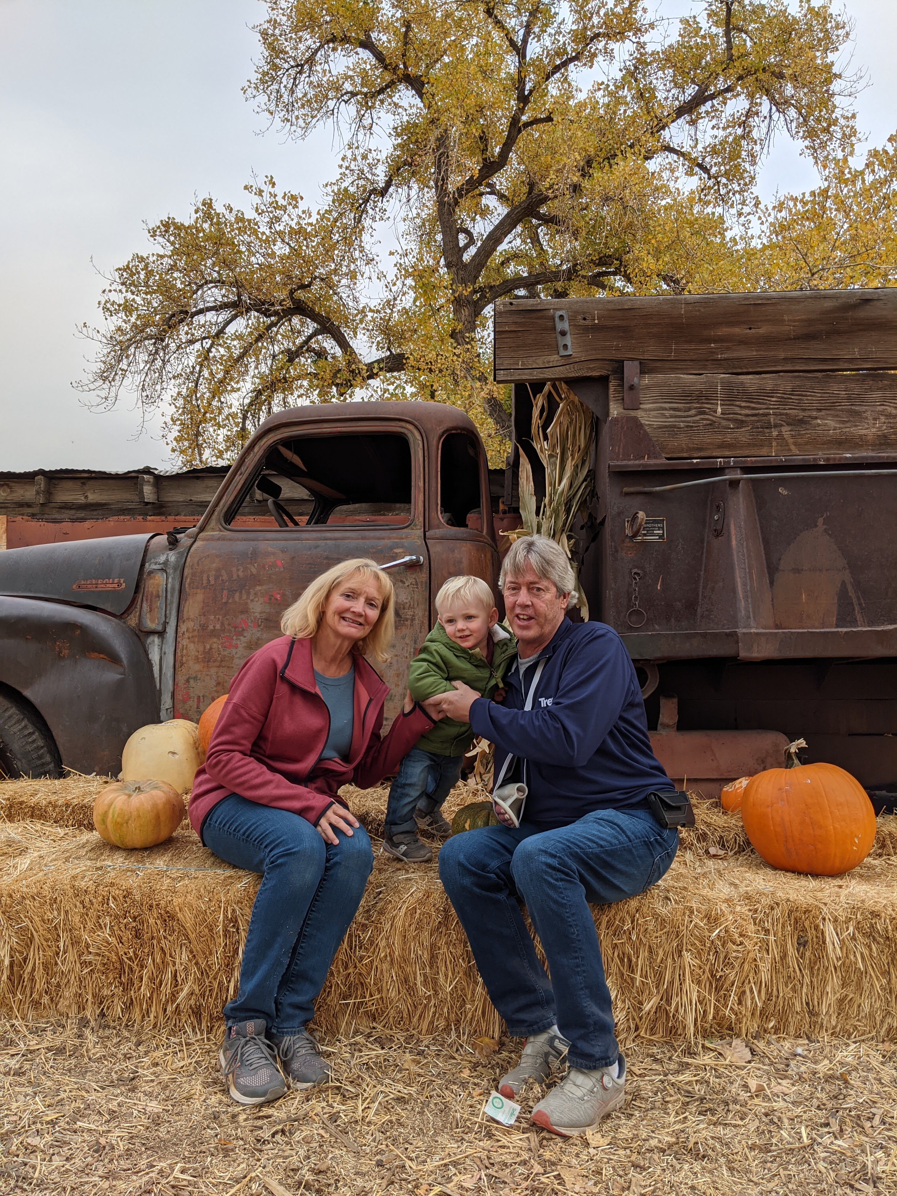 Owen at the pumpkin patch with Grandma Vickie and Grandpa Kim.