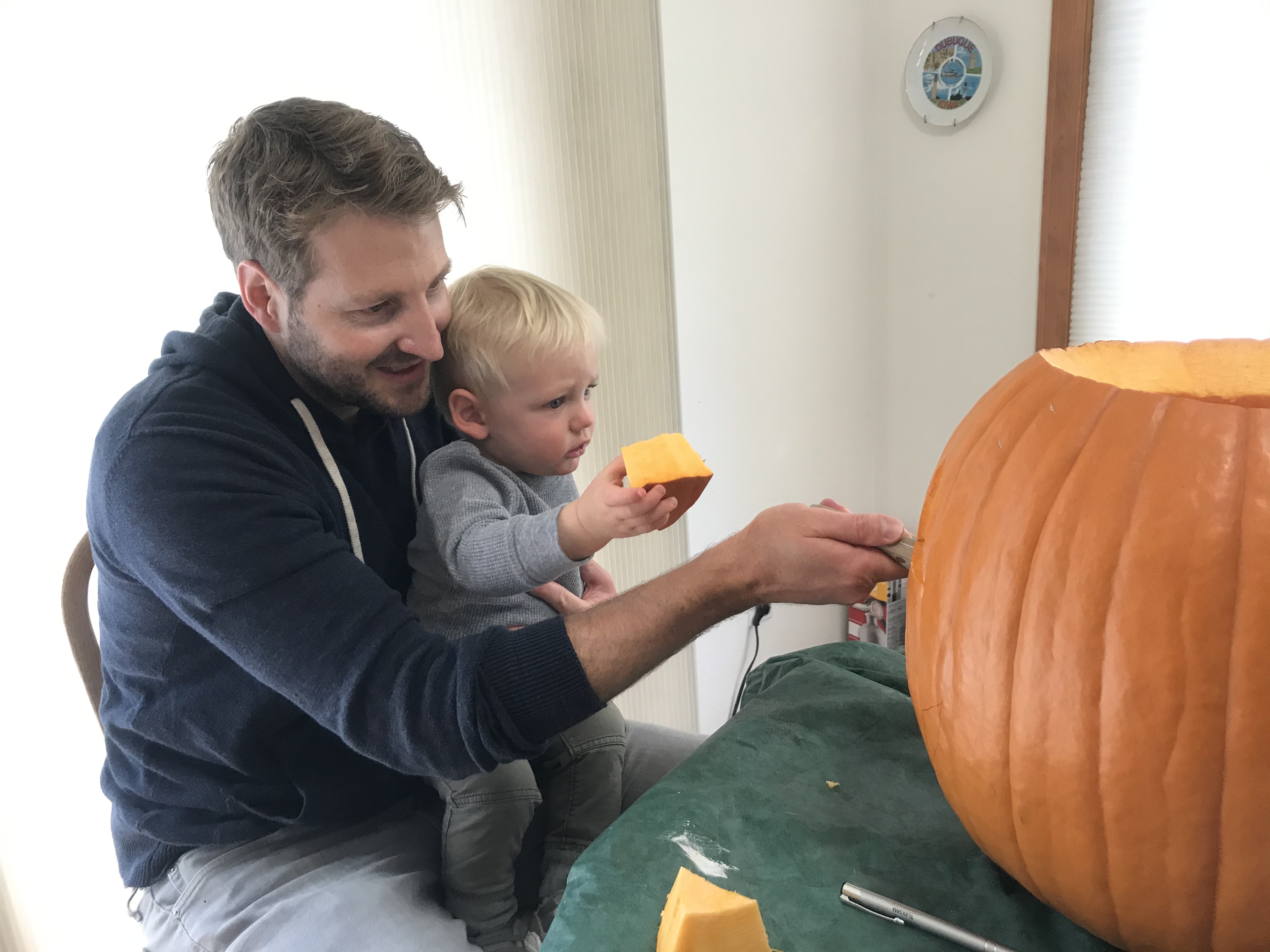 Jeff and Owen carving a pumpkin.