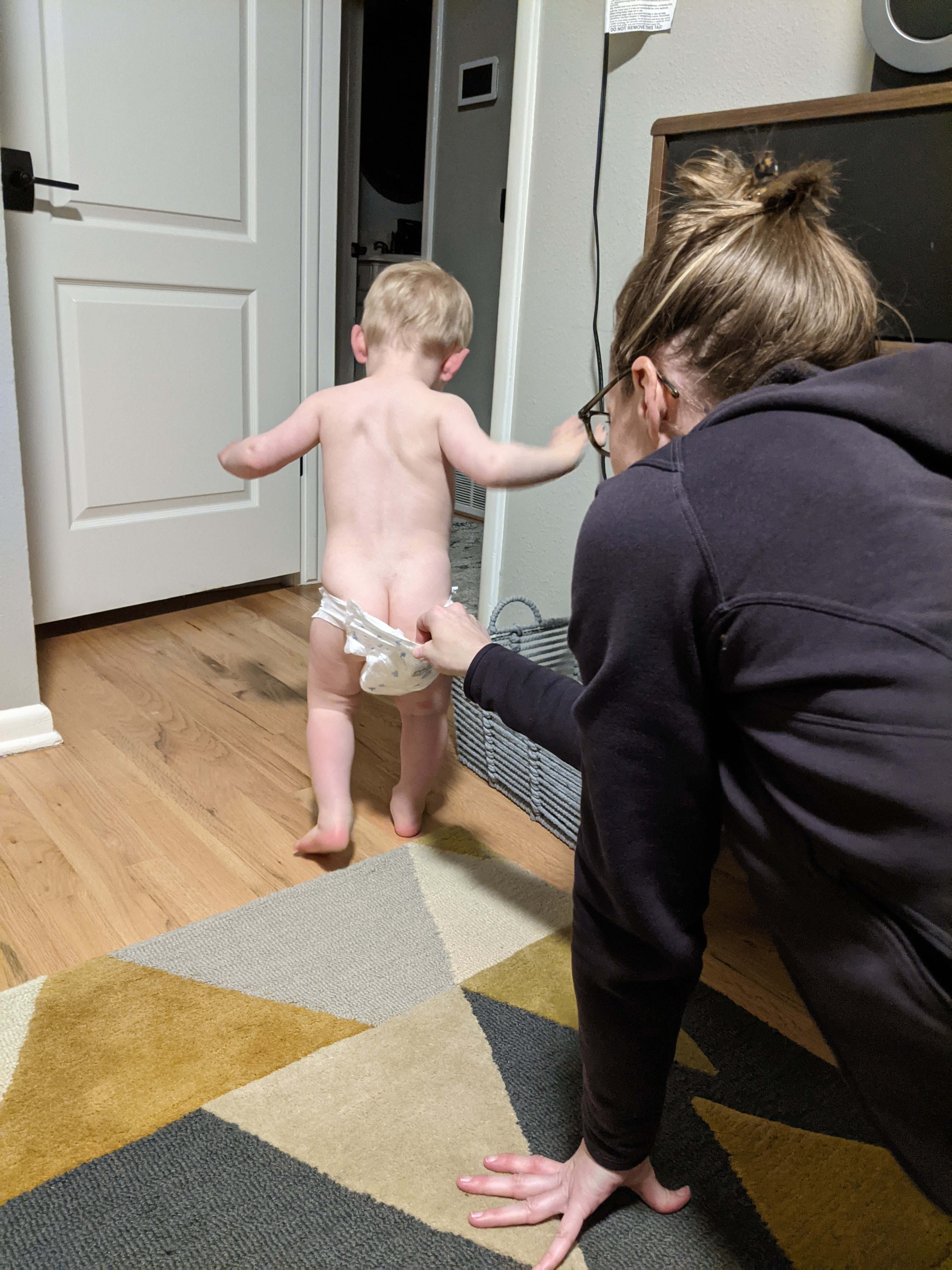 Owen making a break for it with his mom snatching him by the diaper.
